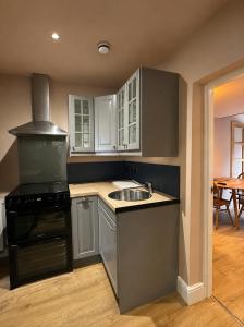 a kitchen with a sink and a stove at Urban Perch in Penrith