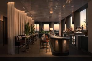 a restaurant with a bar with tables and chairs at Little National Hotel Adelaide in Adelaide