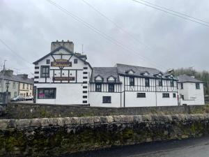 a large white building on the side of a street at Riverside Guesthouse in Charlestown