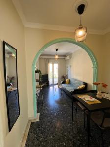 a living room with a blue couch and a table at Port House Apartment in Zakynthos +21 photos
