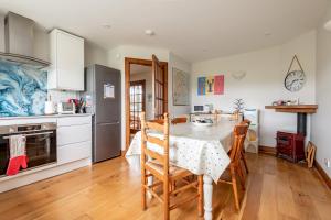 a kitchen with a table and chairs in a room at Stable Cottage - Elie in Elie