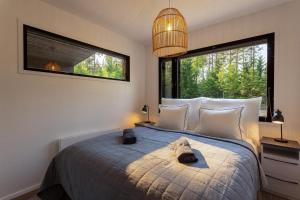 a bedroom with a bed with a large window at Villa Karina - Beachfront with Jacuzzi in Porvoo
