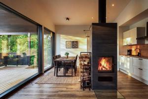 a kitchen and dining room with a fireplace at Villa Karina - Beachfront with Jacuzzi in Porvoo