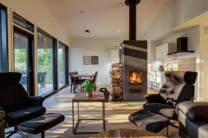 a living room with a couch and a table at Villa Karina - Beachfront with Jacuzzi in Porvoo