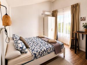 a bedroom with a bed and a large window at Orange Vibes Guest house in Paterna