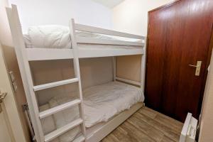 a room with two bunk beds and a door at Studio 5 personnes au revard in Les Déserts