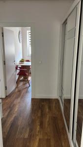 a room with a hallway with a table and a mirror at Cozy Ivory Studio in Voluntari