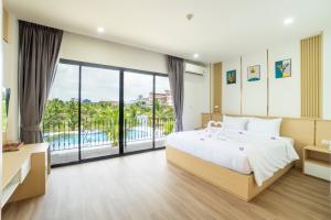a bedroom with a bed and a view of a pool at PP Garden Home in Sathani Lat Krabang +56 photos