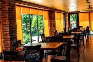 a row of tables and chairs in a restaurant at Hotel Chiatureli in Chiatʼura
