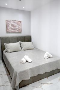 a bedroom with a bed with two towels on it at Diamond Suite in Nea Kallikrateia