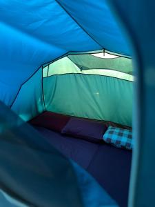 a view of the inside of a tent at Batupineus Riverside in Palayangan