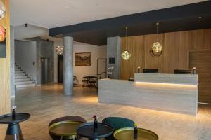a lobby with a counter and some tables and chairs at Hotel Ráztoka in Trojanovice +64 photos