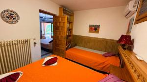 a small room with two beds and a book shelf at Casa Cachito in Benissa +73 photos