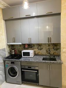 a kitchen with a sink and a microwave at batumi area in Angisa +1 photo
