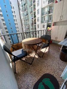a balcony with a table and chairs and buildings at batumi area in Angisa