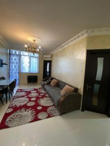 a living room with a couch and a red rug at batumi area in Angisa