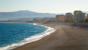 a beach with a group of buildings and the ocean at Locri27 Apartment in Catanzaro Lido