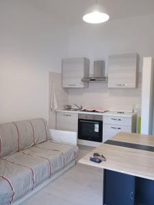 a living room with a couch and a kitchen at Locri27 Apartment in Catanzaro Lido