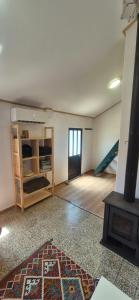 an empty room with a room with a staircase at Studio Juncalinho - Stylish Portuguese Studio in São Teotónio