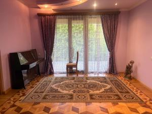 a living room with a large window and a rug at BEAUTI-House in Ijevan