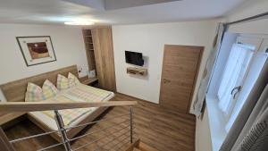 a small room with a bunk bed and a tv at Ferienhaus Trift in Illmitz