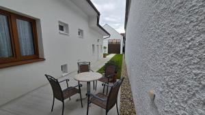 a patio with chairs and a table and a building at Ferienhaus Trift in Illmitz