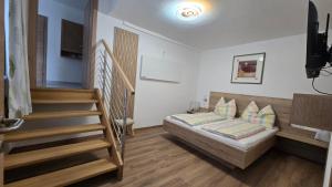 a bedroom with a bed and a stair case at Ferienhaus Trift in Illmitz