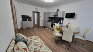 a living room with a couch and a table and chairs at Ferienhaus Trift in Illmitz +9 photos