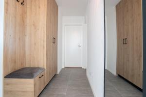 a hallway with wooden cabinets and a mirror at La vue Appartement Gruyère in Bulle
