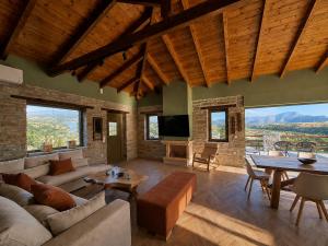 a living room with a couch and a table at Bellevia Stone Pool Villa in Kouvéllai