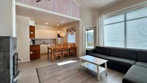 a living room with a couch and a table at Koivulantie 11 A 2 in Tahkovuori