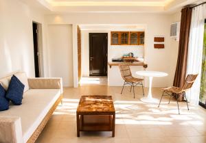 a living room with a couch and a table at Golden Sands Destination Resorts in Daanbantayan