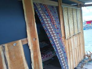 a boat with an open door and a window at Cactos Floating House Experience on Island in Lai Sơn
