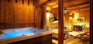 a large blue tub in a room with a bedroom at Lavender Hill, Eko Resort & Wellness in Polzela