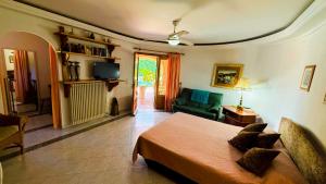 a bedroom with a bed and a living room at Casa Cachito in Benissa