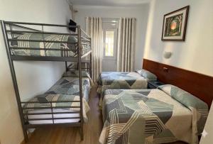a room with two bunk beds and a bed at Hostal Urgell in Balaguer