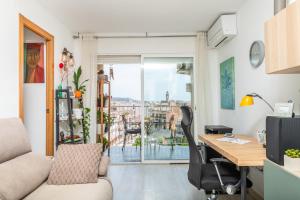 an office with a desk and a table and a window at Playa 5 min, Terraza, AC, WiFi, Parking in Calella