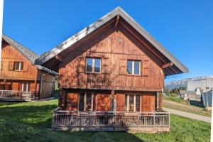 an old wooden house on the side of a field at Chalet MÖKI accès piscine sauna in Les Déserts