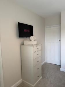 a bedroom with a television on top of a dresser at Tudor House in Osgodby