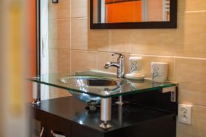 a bathroom sink with a glass bowl on a counter at Les Issignols - Chambre d'hotes in Colombier-le-Vieux +12 photos