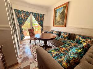 a living room with a couch and a table at LOUIZA HOUSE, vue imprenable entre lac et désert in Lalla Takerkoust +38 photos