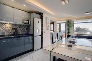 a kitchen with a white refrigerator and a counter at New Luxury Premium in Málaga
