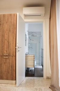 a bathroom with a sink and a wooden door at Suite in Città residence in Isernia +27 photos