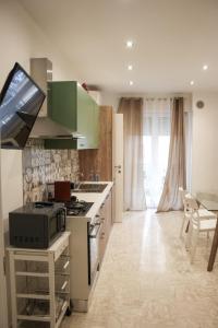 a kitchen with green cabinets and a stove top oven at Suite in Città residence in Isernia