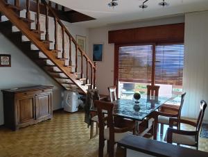 a dining room with a table and a staircase at Villa Franca in Cissano