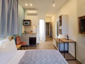 a hotel room with a bed and a kitchen at Shlomtzi Hotel in Jerusalem