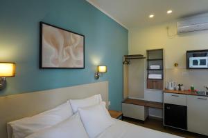 a hotel room with a bed and a kitchen at Shlomtzi Hotel in Jerusalem