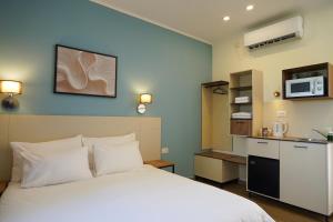 a hotel room with a bed and a kitchen at Shlomtzi Hotel in Jerusalem
