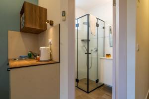a bathroom with a shower and a sink at Shlomtzi Hotel in Jerusalem +54 photos
