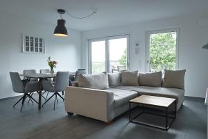 a living room with a couch and a table at Ferienwohnung Bodensee 2 in Meßkirch
